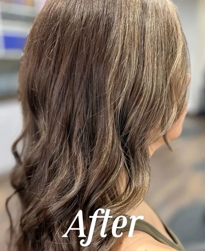 A woman with wavy, light brown hair with blonde highlights is shown from the side; the word "After" is overlaid at the bottom. Copperfalls Aveda Spa & Salon, Castle Rock, CO